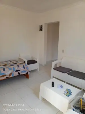 a living room with two beds and a table at Hogar cerca de la playa in Punta Cana