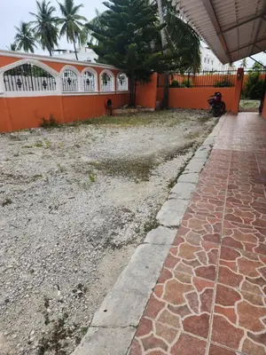 a walkway in front of a house with a motorcycle parked at Hogar cerca de la playa in Punta Cana