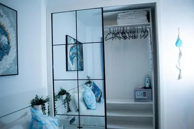a glass shelf with vases in a room at Ocean Blue at Cana Rock Star in Punta Cana