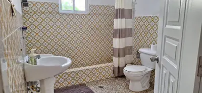 a bathroom with a sink and a toilet at Relaxing and Serene Guest Room in Cancino