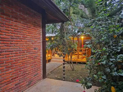 a brick wall with a doorway to a patio at Teonil in Jarabacoa