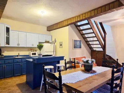 a kitchen with a wooden table and a dining room at Teonil in Jarabacoa