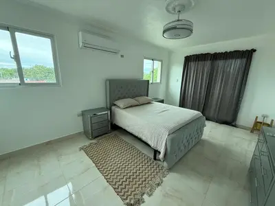 a bedroom with a bed and a rug at Modern Getaway with Private Pool, Montecristi in Villa Vásquez