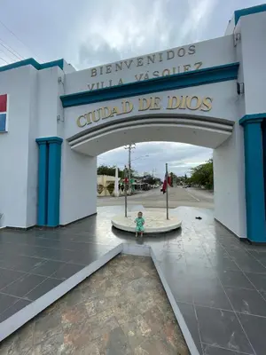 a child stands in front of the entrance to a building at Modern Getaway with Private Pool, Montecristi in Villa Vásquez