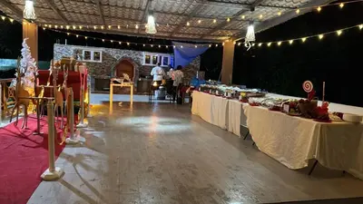 a banquet hall with two tables with food on them at Rancho paraíso escondido in San Pedro de Macorís