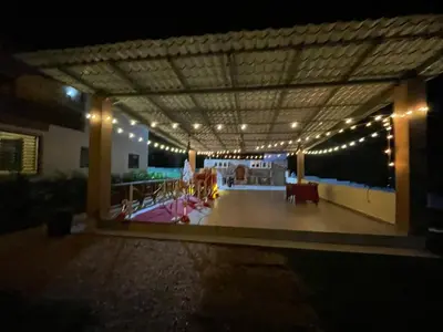 a lit up patio at night with lights at Rancho paraíso escondido in San Pedro de Macorís