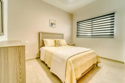 a bedroom with a bed and a window at Luxury apartment in hard rock punta cana in Punta Cana