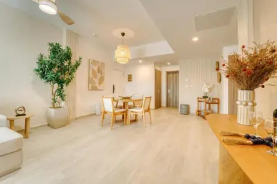 a kitchen and living room with a table and chairs at Luxury apartment in hard rock punta cana in Punta Cana