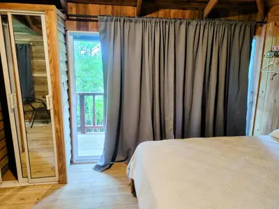 a bedroom with a bed and a large window at Montaña viva in Sánchez