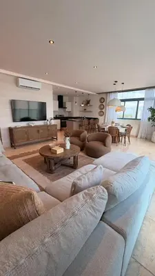 a living room with a couch and a table at Family Friendly Beach Apartment in Juan Dolio in Los Corrales