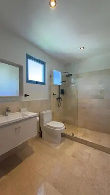 a bathroom with a toilet and a sink and a shower at Family Friendly Beach Apartment in Juan Dolio in Los Corrales