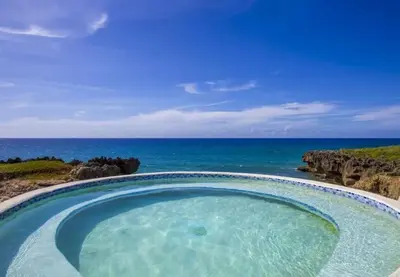 a hot tub with the ocean in the background at Bubble Glamping, King bed, we have a 8 units like this in Sosúa