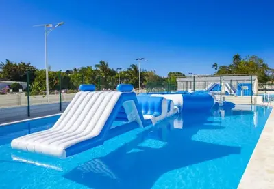 a water slide in a pool at a water park at Bubble Glamping, King bed, we have a 8 units like this in Sosúa