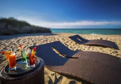 a table with two drinks on the beach at Bubble Glamping, King bed, we have a 8 units like this in Sosúa