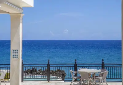 a patio with a table and chairs and the ocean at Bubble Glamping, Family 2 beds, we have a 12 units like this in Sosúa