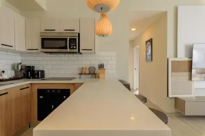 a kitchen with a white counter top and a microwave at Ático ONA White Sands | Terraza & Picuzzi privado in Punta Cana