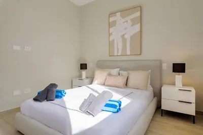 a bedroom with a large white bed with two night stands at Ático ONA White Sands | Terraza & Picuzzi privado in Punta Cana