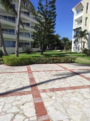 a shadow of a building and a palm tree at comfortable apartment in La Puntica de Juan Dolio
