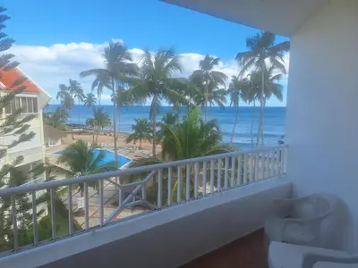 a room with a balcony with a view of the ocean at marina view in La Puntica de Juan Dolio