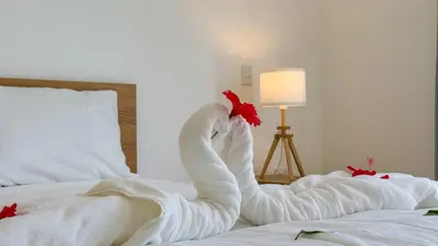a white swan made out of towels on a bed at Sosua Ocean Village - Villas Marinas 27B in Sosúa