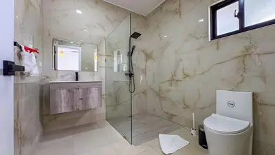 a bathroom with a shower and a toilet at Sosua Ocean Village - Villas Marinas 27B in Sosúa