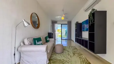 a living room with a couch and a mirror at Sosua Ocean Village - Villas Marinas 27B in Sosúa