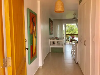 a hallway of a home with a view of a porch at Cadaques Bayahibe Family Apts in Bayahibe