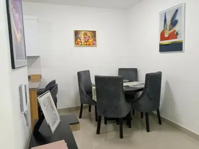a dining room with black chairs and a table at Elton de Gurabo es tu lugar in Santiago de los Caballeros
