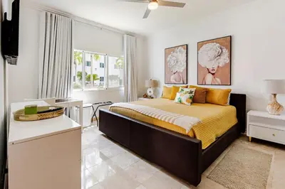 a bedroom with a large bed and a window at Beautiful 2 bedroom apartment on the beach in Punta Cana