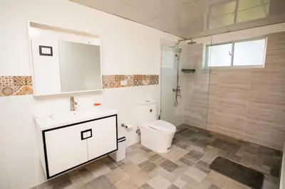 a bathroom with a toilet and a sink and a shower at Apartment with Pool, Cofresi in San Felipe de Puerto Plata