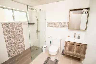 a bathroom with a toilet and a shower and a sink at Apartment with Pool, Cofresi in San Felipe de Puerto Plata