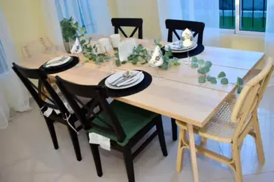 a wooden table with chairs and a dining room at Casa Bayaguana Real in Bayaguana
