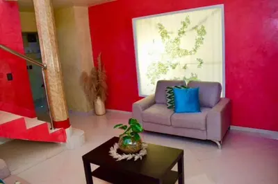 a living room with a couch and a table at Casa Bayaguana Real in Bayaguana