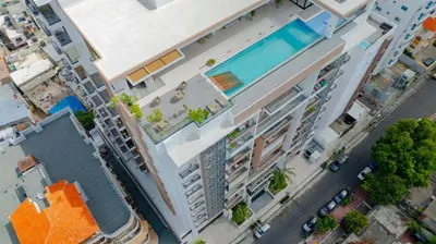 an overhead view of a building with a swimming pool at Luxstay SDQ in Santo Domingo