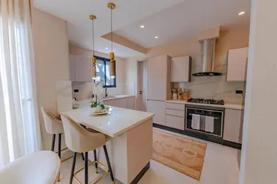 a kitchen with white cabinets and a white counter top at Luxstay SDQ in Santo Domingo