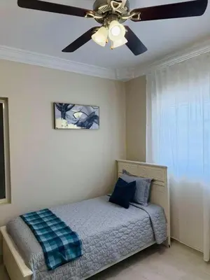 a bedroom with a bed with a ceiling fan at Punta Cana Apartment Tropical Escape near Beach in Punta Cana