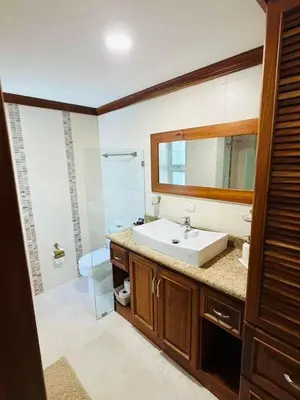 a bathroom with a sink and a toilet and a mirror at Punta Cana Apartment Tropical Escape near Beach in Punta Cana