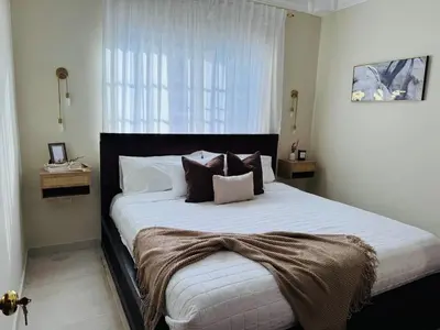 a bedroom with a large bed with pillows on it at Punta Cana Apartment Tropical Escape near Beach in Punta Cana