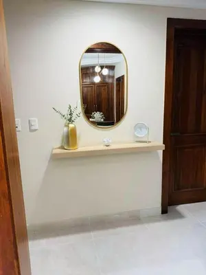 a mirror sitting on a shelf in a room at Punta Cana Apartment Tropical Escape near Beach in Punta Cana