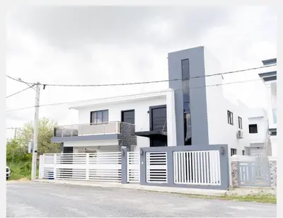 a white house with a fence in front of it at Villa Joa in Punta Cana