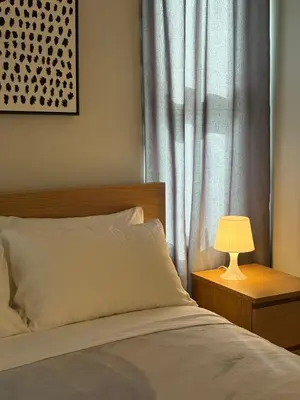 a bedroom with a bed and a table with a lamp at 2Bedroom Apt Pool Beach Restaurants in Punta Cana