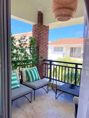 a patio with two chairs and a balcony at 2Bedroom Apt Pool Beach Restaurants in Punta Cana