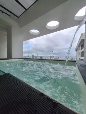 a swimming pool with water in a building at Miraculus Penthouse With Private Jacuzzi in Santo Domingo