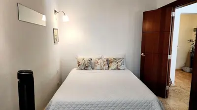 a small bedroom with a bed with white sheets and pillows at BEACH FRONT 3 Bedroom Villa with Pool Sleeps 7 in Las Terrenas