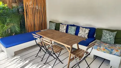 a living room with a blue couch and a table and chairs at BEACH FRONT 3 Bedroom Villa with Pool Sleeps 7 in Las Terrenas