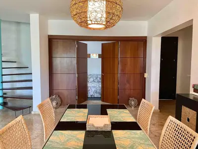 a dining room with a table and chairs and a chandelier at BEACH FRONT 3 Bedroom Villa with Pool Sleeps 7 in Las Terrenas