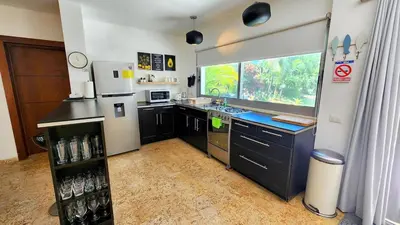 a kitchen with a refrigerator and a sink and a window at BEACH FRONT 3 Bedroom Villa with Pool Sleeps 7 in Las Terrenas