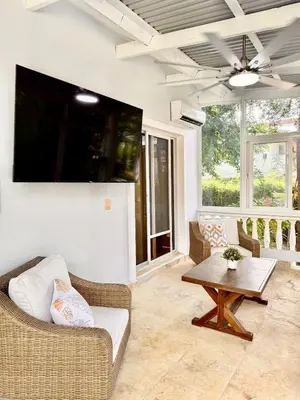 a living room with a couch and a table at Charming 2 bed 2bath villa 77B with private pool in Sosúa