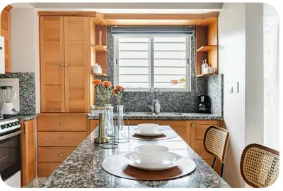a kitchen with a table with two plates on it at Un bonito amanecer in Santo Domingo