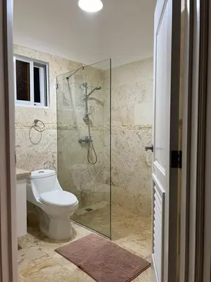 a bathroom with a toilet and a glass shower at Villa 156, 3 bedrooms and 3 bathrooms with private pool in Sosúa